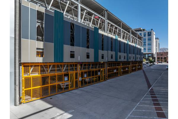 A long row of parking garage doors are open. at Paperbox Lofts Apartments, Salt Lake City  , 84101